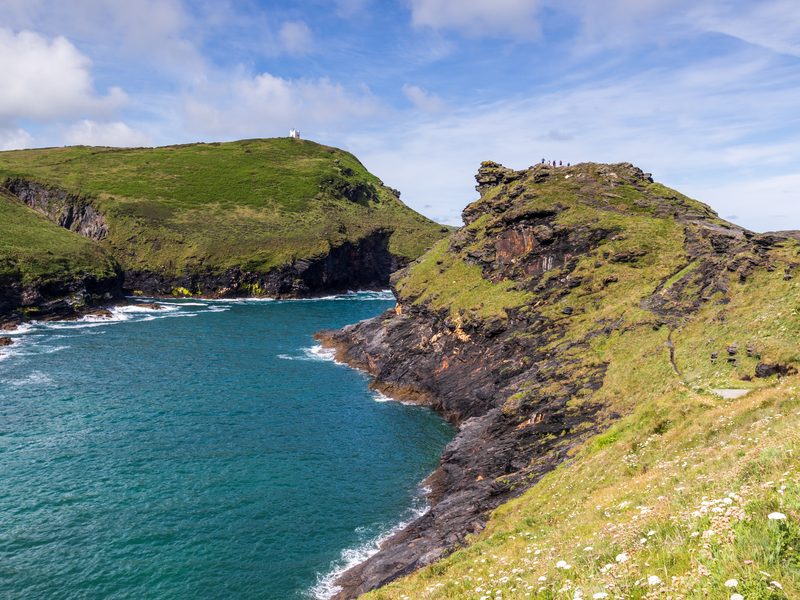 A rocky headland and deep blue sea on the north Cornwall coast